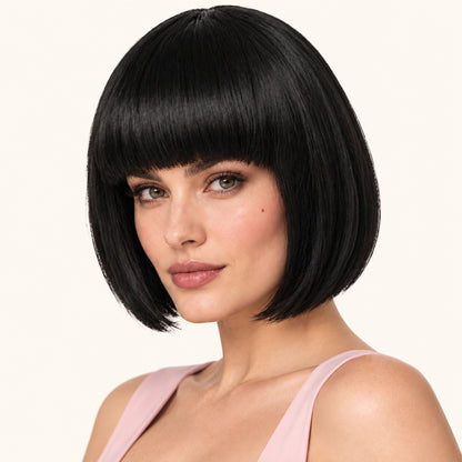 Model wearing a black straight bob wig with full fringe.