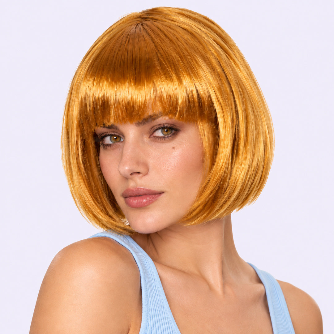 Model wearing a gold straight bob wig with full fringe.