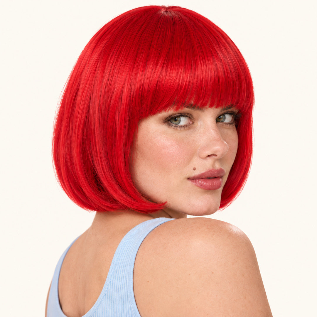 Model wearing a red straight bob wig with full fringe.